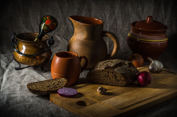 Obraz na płótnie Canvas Still life with homemade bread and pottery