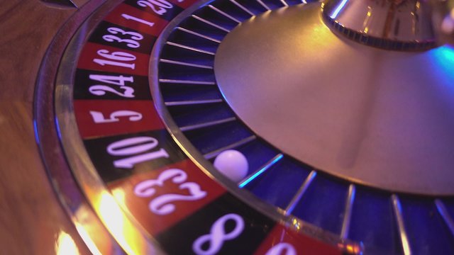 Roulette Wheel in a casino - ball in field 23 red