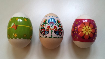 Three colorful Easter eggs on a white table