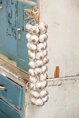 String of garlic bulbs hanging in hungarian rural kitchen