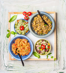 Various salads dish on light rustic background. Home salad bar. Healthy food and vegetarian Eating concept