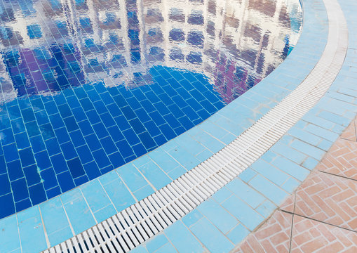 Building reflected in the blue deep and clean pool