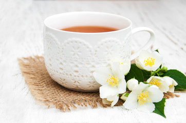 Fototapeta na wymiar Cup of tea with jasmine flowers