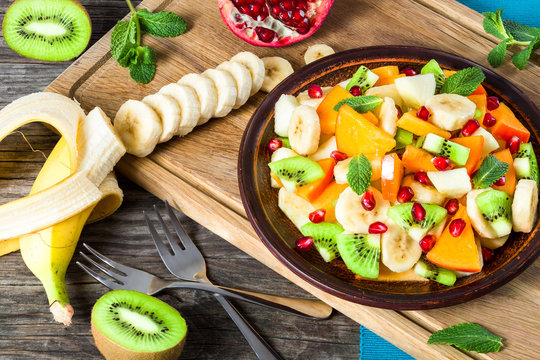 fruit salad in a clay brown dish, close-up, top view - Powered by Adobe