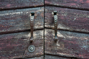 Old doorknobs, doorknockers and handles on ancient doors