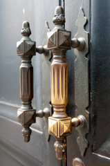 Old doorknobs, doorknockers and handles on ancient doors