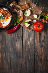 fried eggs with bacon in a pan close-up 