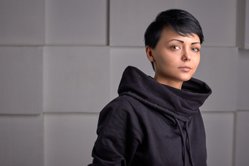 Young black sport wear girl on white cube background