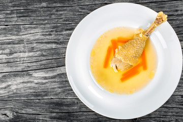 soup with carrot and chicken leg decorated with dill, .top-view