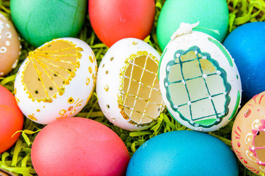 Easter eggs - Easter painted eggs in basket on grass - symbol of Easter
