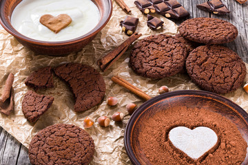 Chocolate cookies, chocolate with hazelnuts on a parchment paper