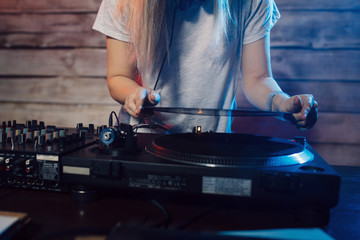 Cute dj woman having fun playing music at club party