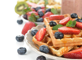 Waffles with berries and caramel sauce