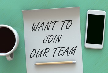 WANT TO JOIN OUR TEAM, message on paper, smart phone and coffee on table