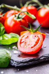 Tomatoes. Cherry tomatoes. Cocktail tomatoes. Fresh grape tomatoes carafe with olive oil on table. Tned photo