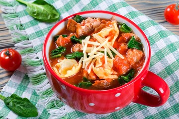 tortellini soup with italian sausages, spinach, tomato, parmesan cheese