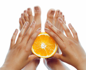 manicure pedicure on afro-american tann skin hands holding orange, healthcare concept