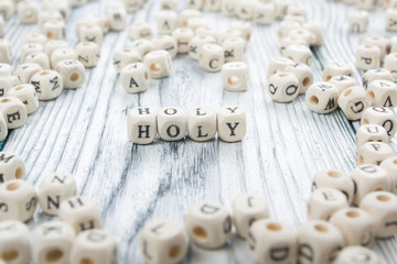 text of HOLY on wood cubes. Wooden Abc