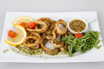 Seasoned calamari with lemon, tomatoes and spices.