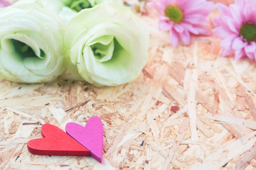 red pink heart shape on flower and wooden background