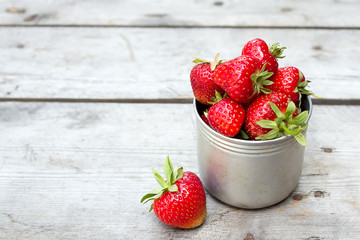 Ripe red strawberries on wooden table