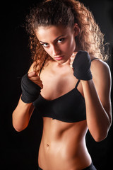 Portrait of young beautiful fitness woman, isolated on black background