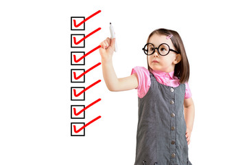 Cute little girl wearing business dress and checking on checklist boxes. White background.