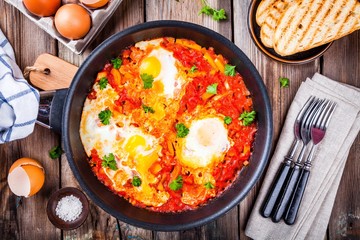 Shakshuka. Fried eggs with tomato, paprika and parsley