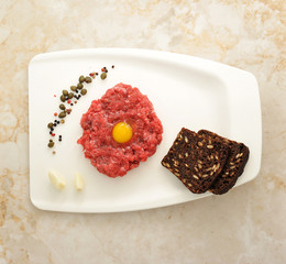 minced beef with raw egg on a white Board