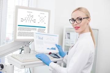 Skillful female researcher working with modern technology