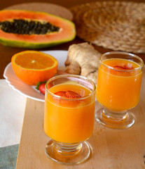 Healthy orange, papaya and ginger smoothie. 