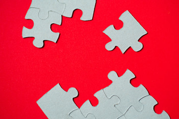 cardboard puzzles pieces on a red background