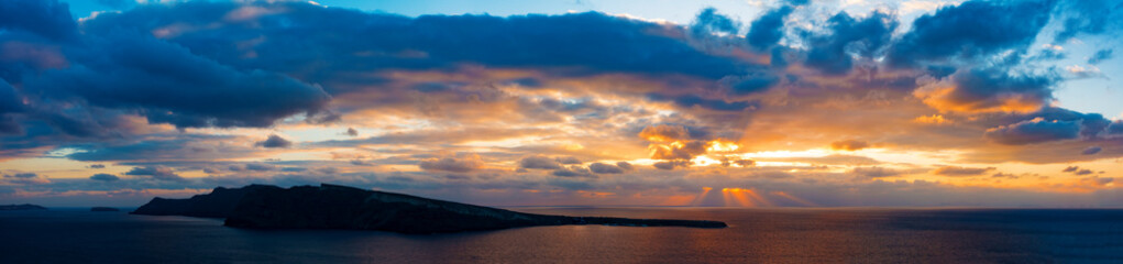Fototapeta na wymiar Sunset in sea and island on horizon