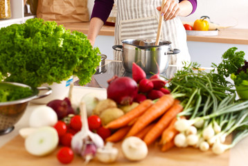 Young Woman Cooking in the kitchen. Healthy Food