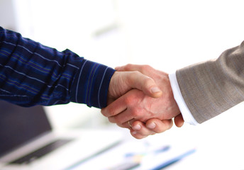 Business handshake. Two businessman shaking hands with each other in the office