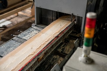 At sawmill. Image of sawing wood with laser marks