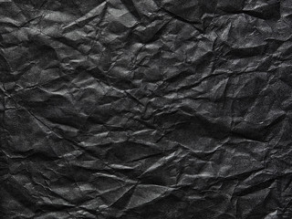 Naklejka premium Black crumpled paper as a background