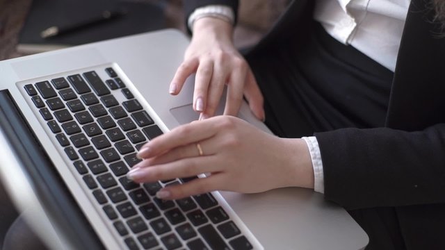 Close up of a woman hands typing in her office