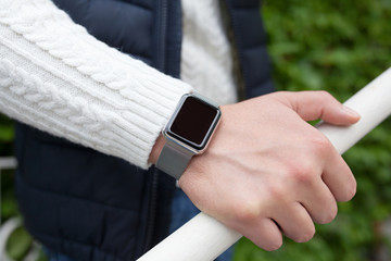 man with smart watch on the hand in the street