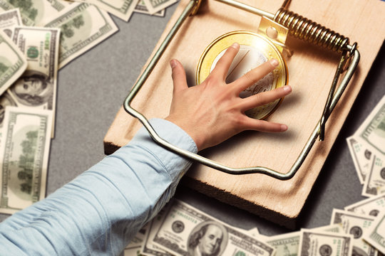 Male hand picking a gold coin