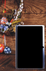  Holiday wreath with colored eggs and tablet pc with blank screen