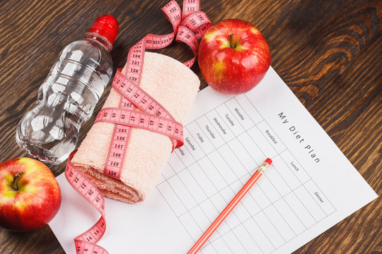Diet plan, apples and towel, wooden background