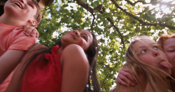 mixed race person of laughing children in a summer park