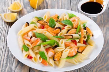 penne pasta salad with shrimps, mussels and baby spinach