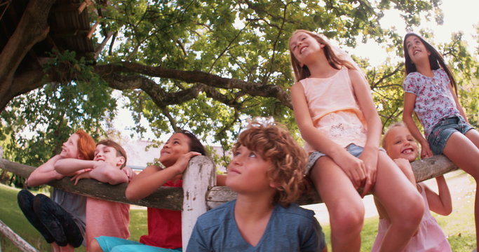 mixed race person of laughing children in a summer park