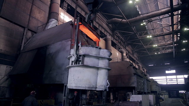 Smelting of liquid metal in tank, container, reservoir at the metallurgical plant.  HD.