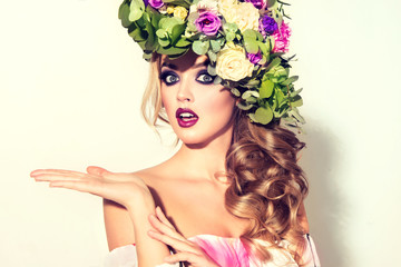 Girl spring . Beautiful model with flower wreath on his head . Makeup smoky eyes . Summer girl with...