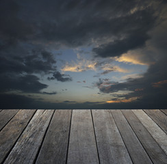 Empty old wood floor with dramatic dark sky before the storm at