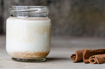 Cinnamon yogurt, rustic background.