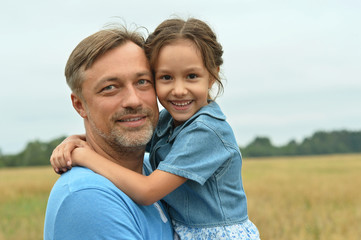 Dad with daughter in field